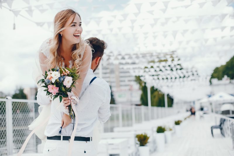 Beautiful bride with her husband in a park